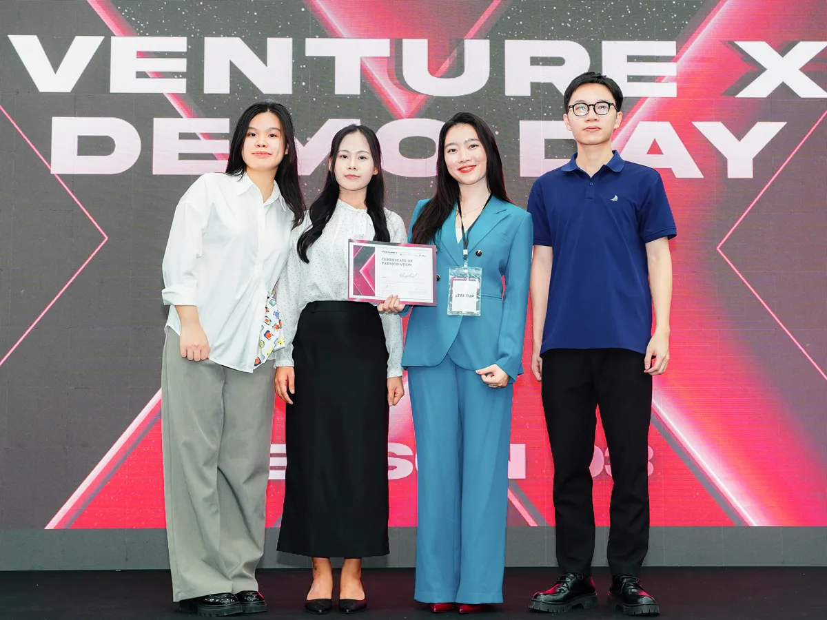 The GlowBal team on stage at Venture X Demo Day with its certificate